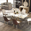 A modern dining room setup featuring a rectangular marble-patterned dining table with gold-tone legs, surrounded by six contemporary chairs in brown and cream upholstery, placed on a gray area rug in a styled living space.