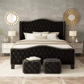 Black upholstered bed with matching ottoman in a bedroom setting