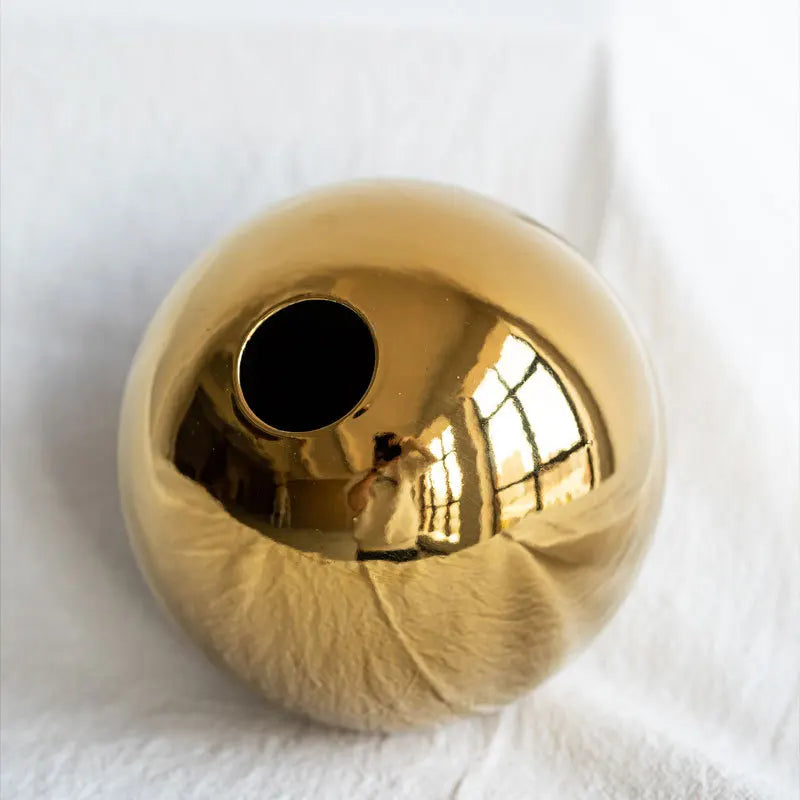 Close up of the gold planter on a white background