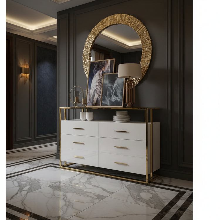 White dresser with gold accents and decorative items in an entryway with marble floors