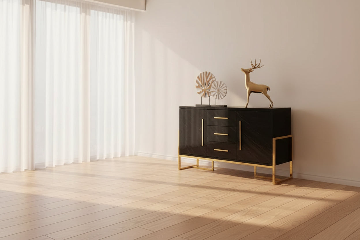 Elegant gold stainless steel console cabinet in a bright room with natural light and decorative elements.