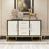 Modern sideboard with gold accents and decorative items against a neutral wall.