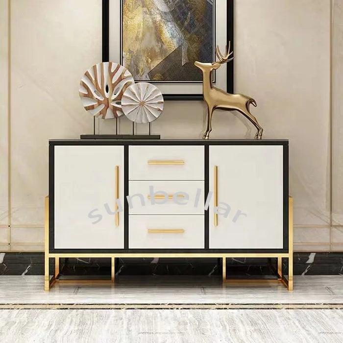 Gold stainless steel console cabinet with tempered glass top and decorative items on display.