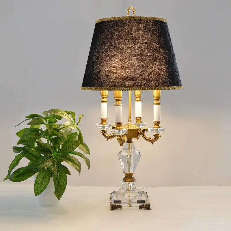 K9 crystal table lamp with fabric shade elegantly illuminating a stylish interior.