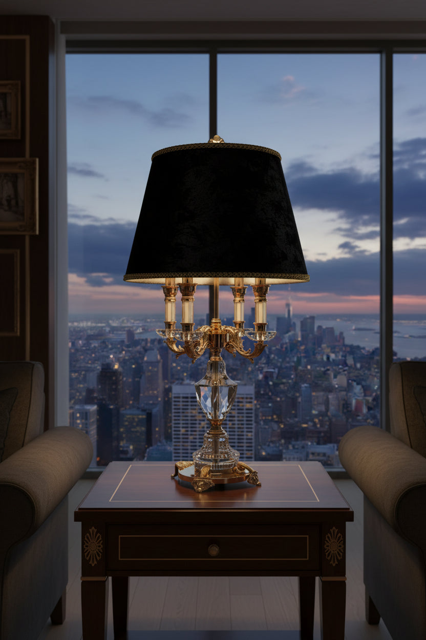 K9 crystal table lamp with fabric shade illuminating a modern living room with city skyline view.