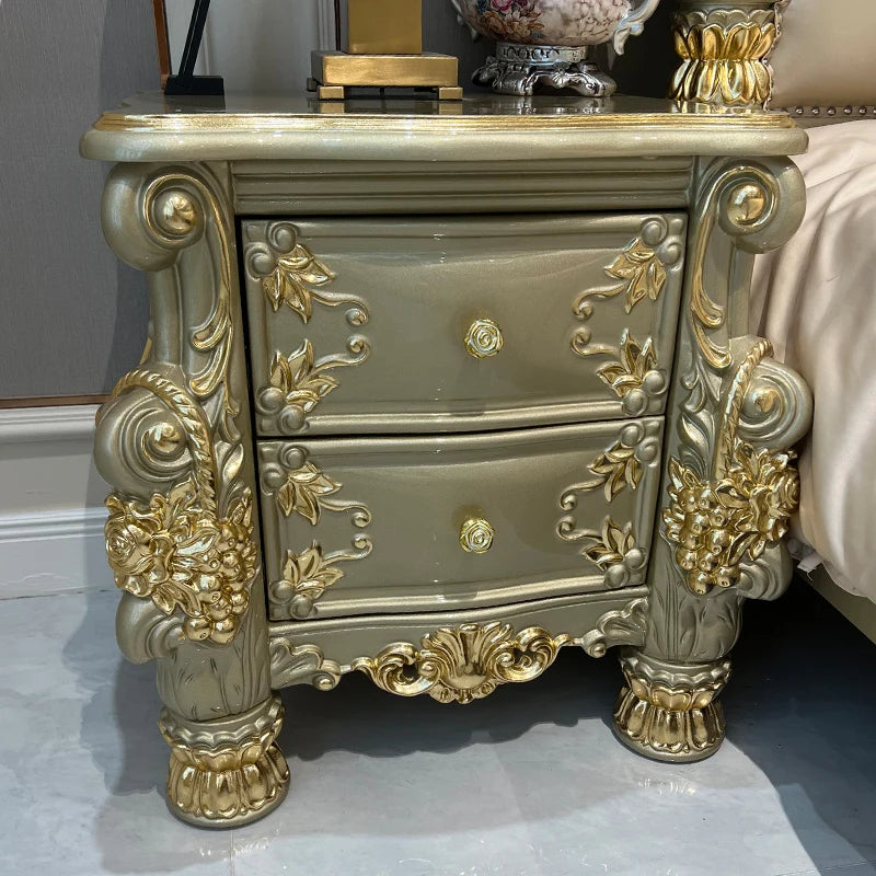 ornate nightstand with two drawers featuring gold leaf detailing and floral accents, complementing luxury bedroom decor