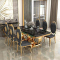 An elegant dining room set featuring a rectangular black marble-top table with ornate gold legs, surrounded by six matching high-back chairs with black upholstered seats and gold frames.