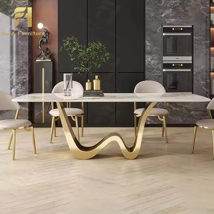 Luxury marble dining table with gold legs featuring a curved base and seating for eight guests in a modern dining room.