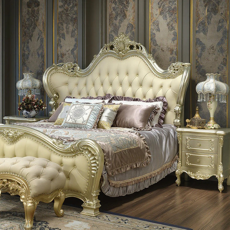 Luxurious bedroom with an ornate bed and matching nightstands.