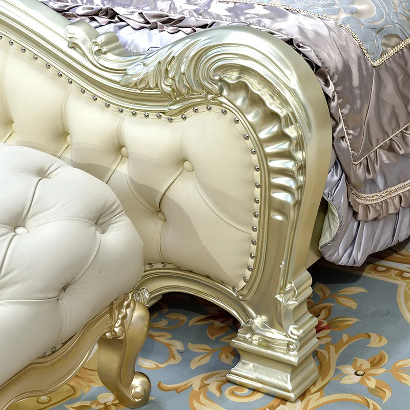 European style solid wood bed with ornate gold detailing and luxurious upholstery in a villa master bedroom.