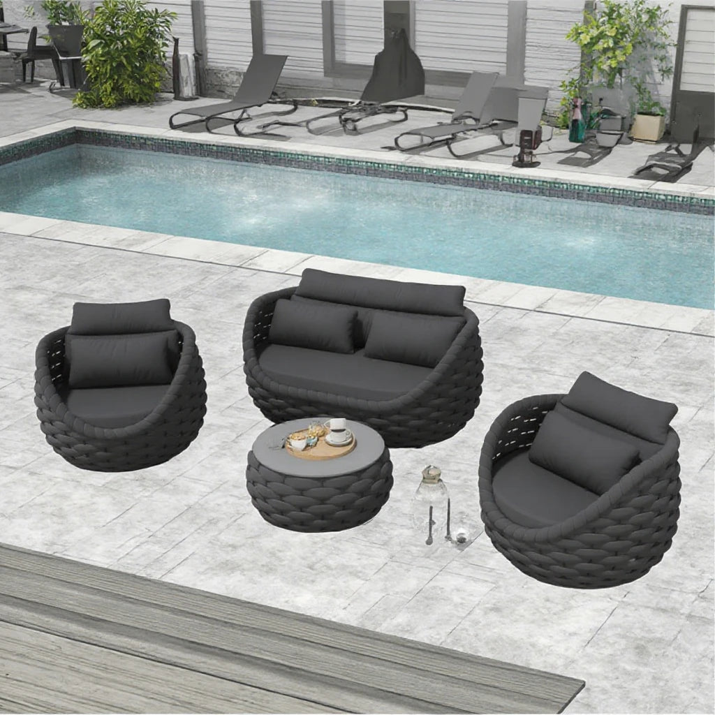 Outdoor patio furniture set with chairs and a table by a pool