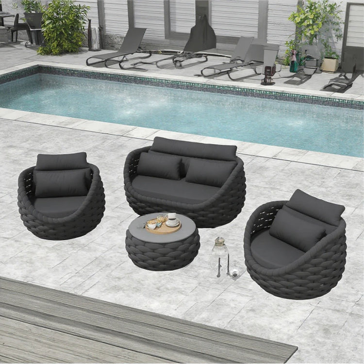 Outdoor patio furniture set with chairs and a table by a pool