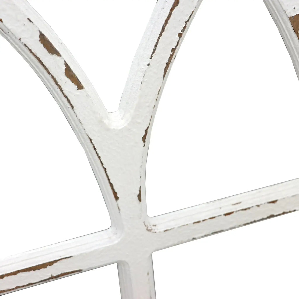 Close-up of a white decorative window frame with a rustic finish on a white background