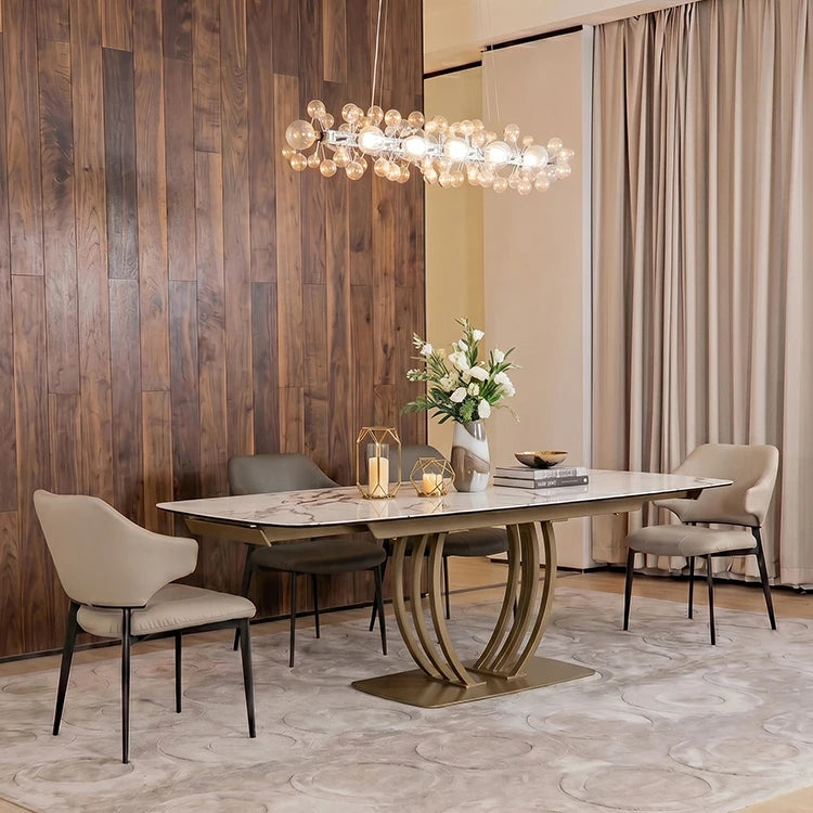 Sintered stone extendable dining table with metal frame in a modern dining room setting.