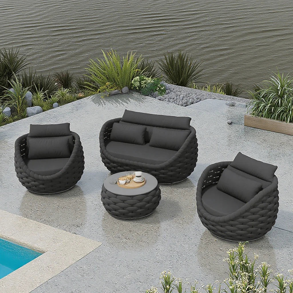 4-piece outdoor aluminum sofa set dark gray with loveseat, two chairs, and tea table by the poolside.