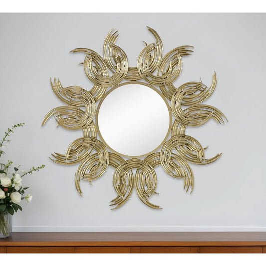 Decorative wall mirror with sunburst design on a white wall.