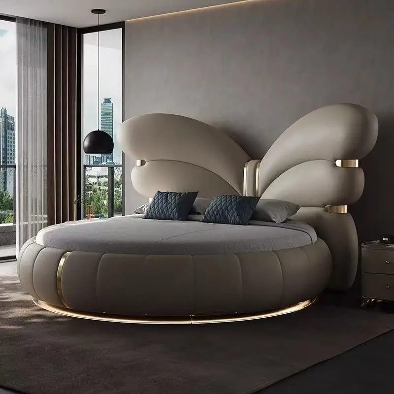 Genuine leather butterfly round bed with soft sculptural design and gold accents in modern bedroom.