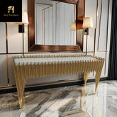 Gold console table with decorative design in a modern interior setting