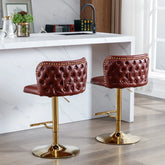 Two brown bar stools with gold bases in a kitchen setting.