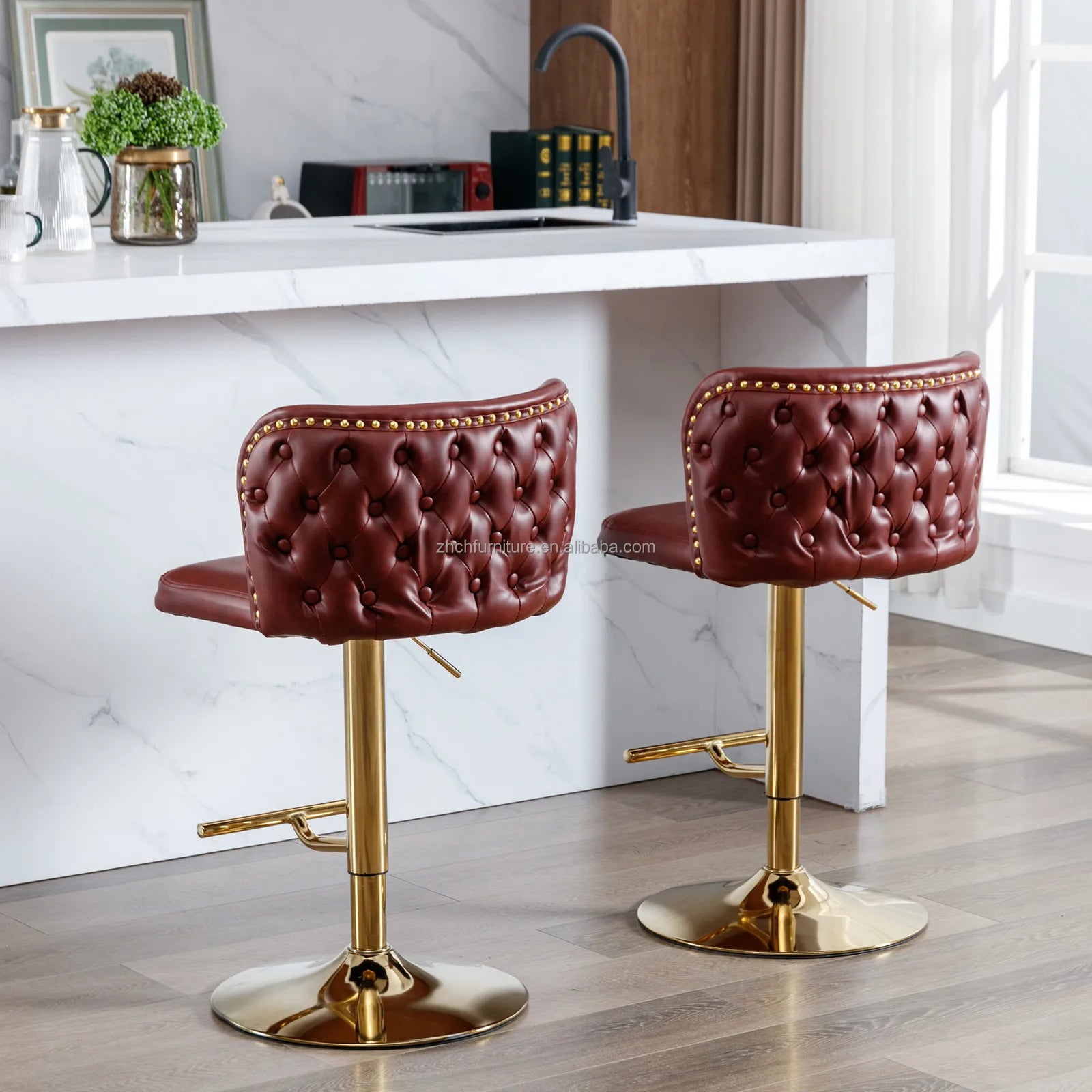 Leather Swivel Adjustable Bar Stools in tufted burgundy PU leather with golden base and nailhead trim.
