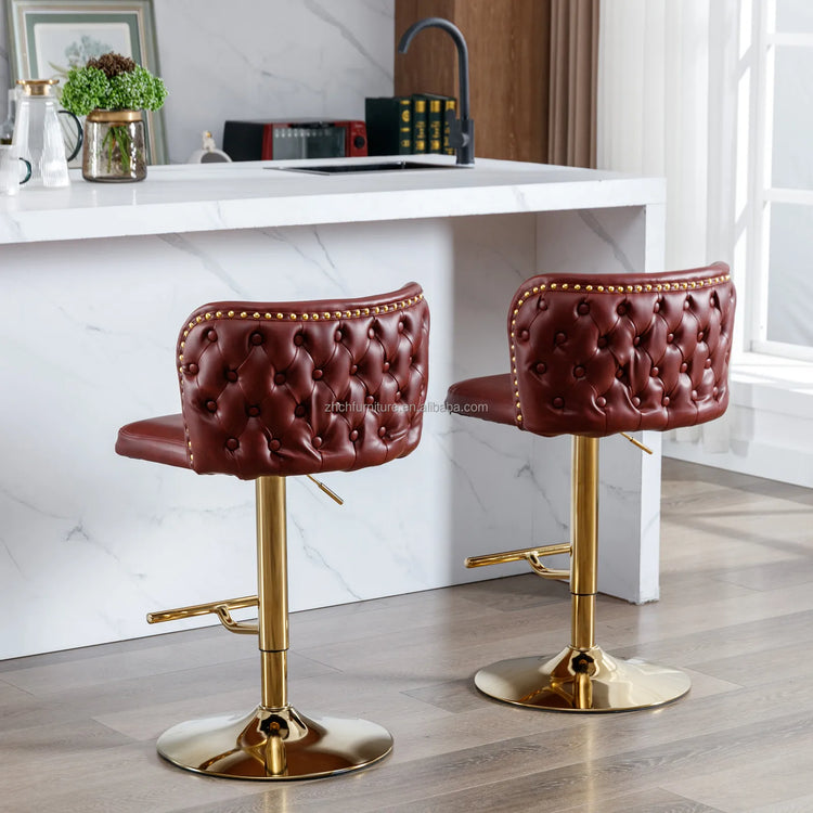 Two brown bar stools with gold bases in a kitchen setting.