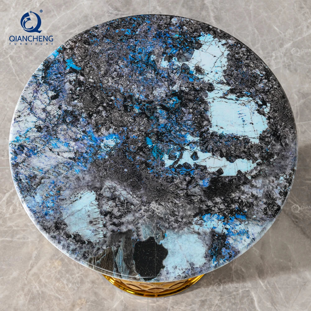 Luxury gold marble side table with stunning blue and gray marble top, perfect for modern living room decor.