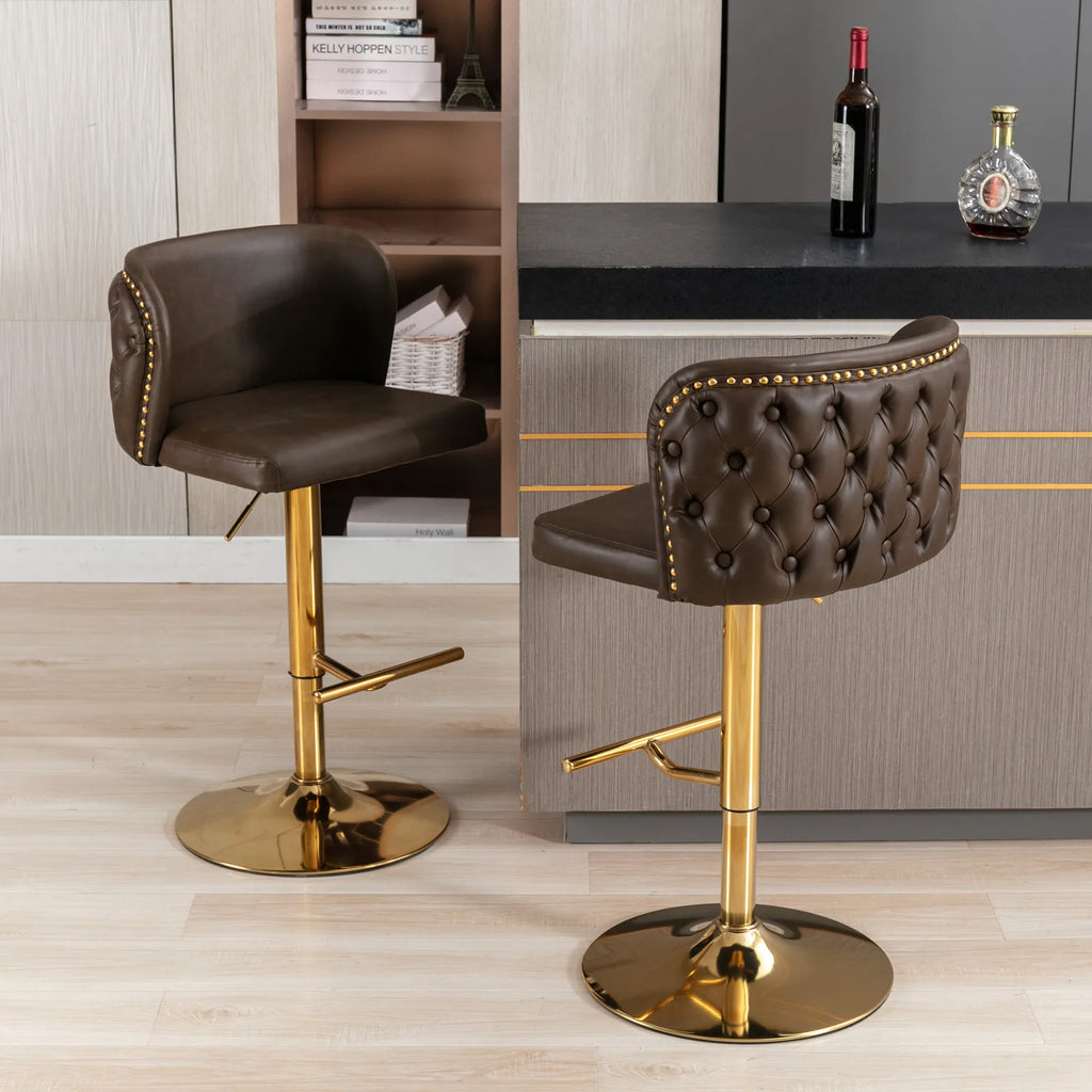 Set of 2 leather swivel adjustable bar stools with tufted brown PU leather and golden bases in a modern kitchen.