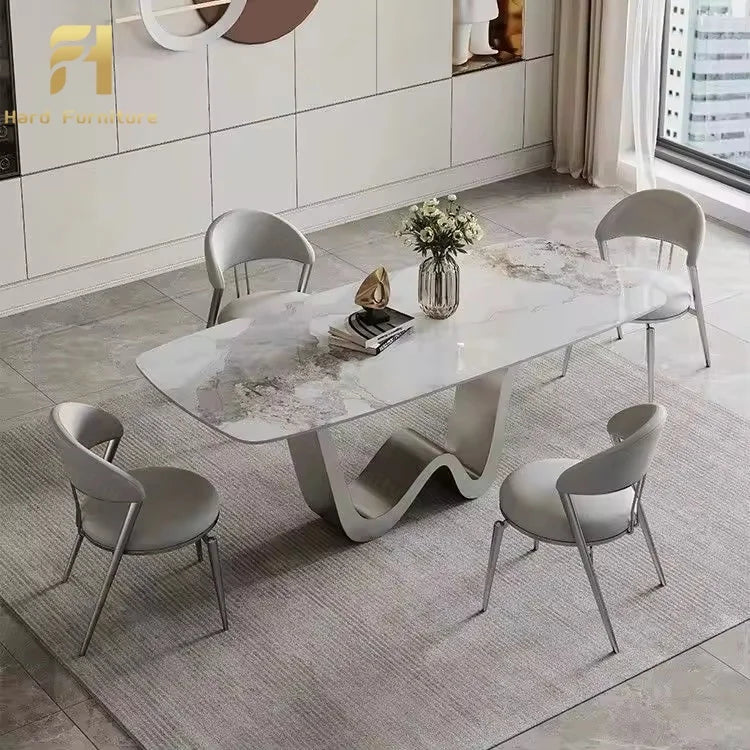 Luxury marble dining table with gold legs surrounded by stylish chairs in a modern dining room setting.