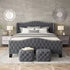 Gray upholstered bed with matching ottomans in a bedroom setting.