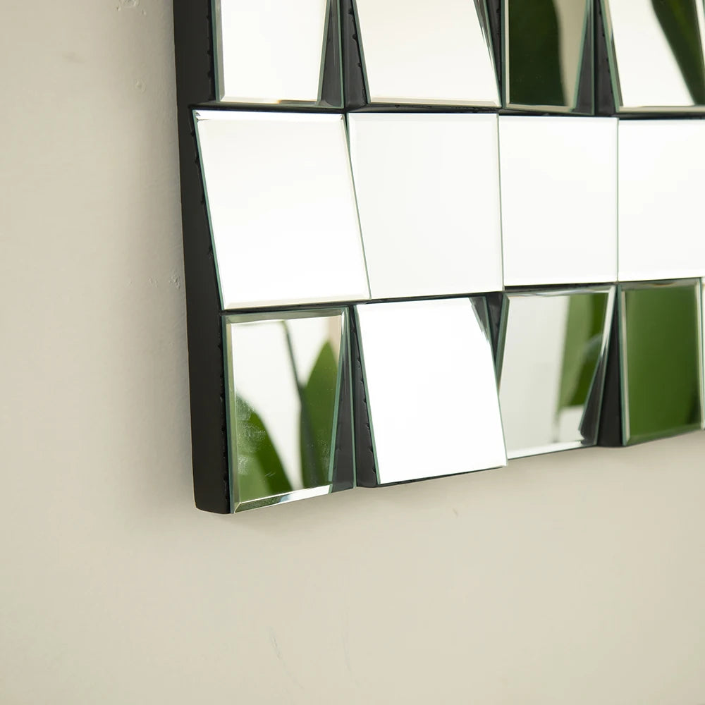Decorative mirror with geometric design on a plain wall