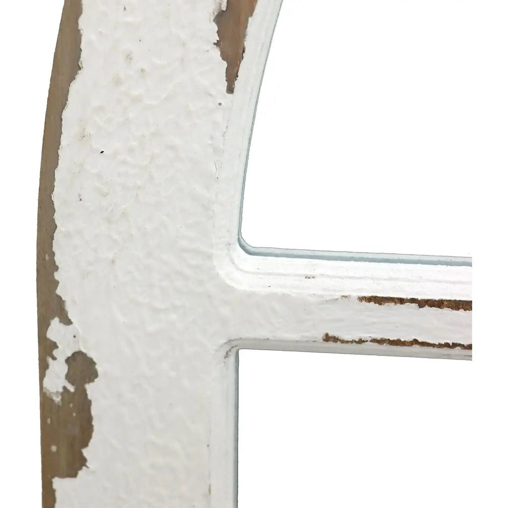 Close-up of a window frame with white foam insulation on a brown wall.