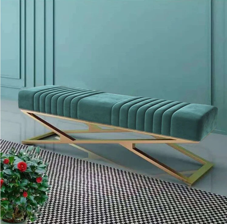 Modern tufted velvet bench with stainless steel base in a stylish living space.