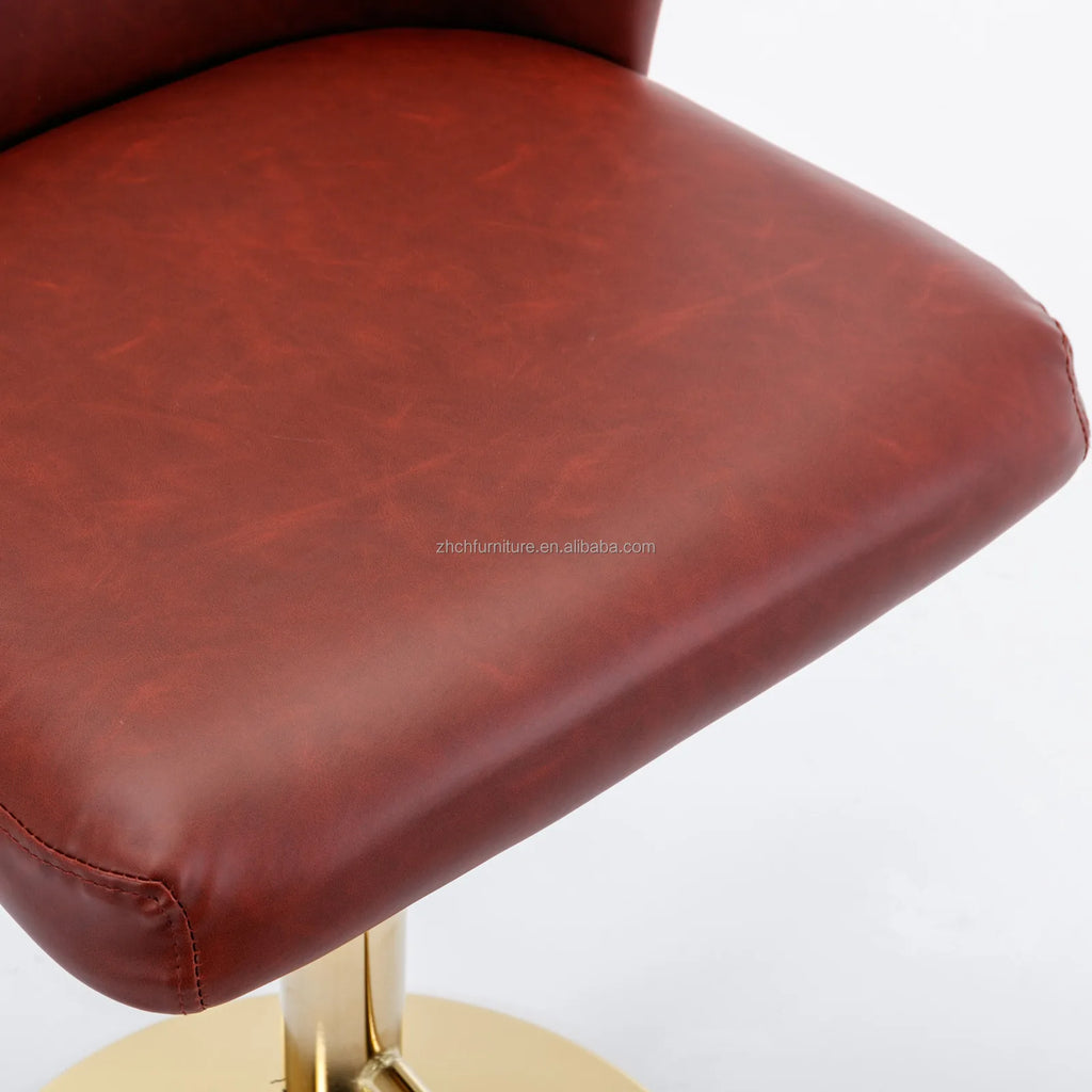 Close-up of Leather Swivel Adjustable Bar Stools with tufted PU leather seat and golden base.