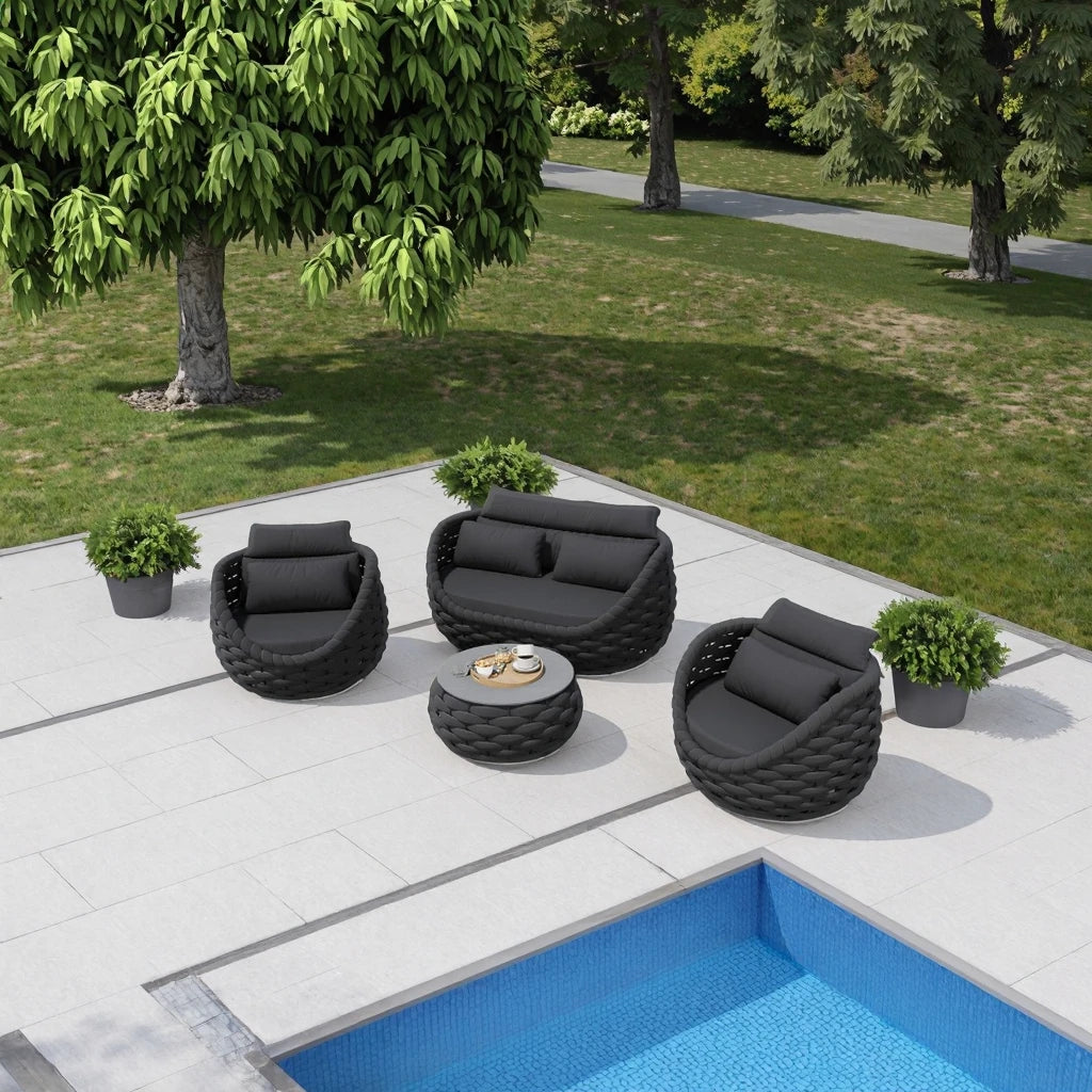 4-piece outdoor aluminum sofa set dark gray with loveseat, two chairs, and tea table by the poolside in a garden.
