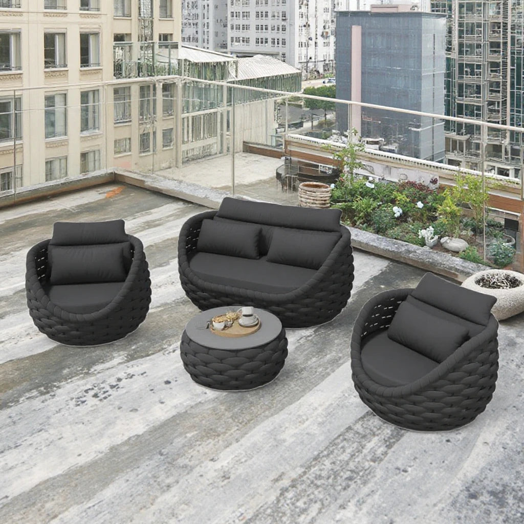 4-Piece outdoor aluminum sofa set dark gray with loveseat, two chairs and tea table on a modern patio.