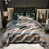 Luxury black and gold yarn-dyed jacquard bedding set on bed with dark tufted headboard in elegant bedroom