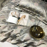 Luxury black and gold yarn-dyed jacquard bedding set made from premium Egyptian cotton with satin finish and intricate hexagonal pattern