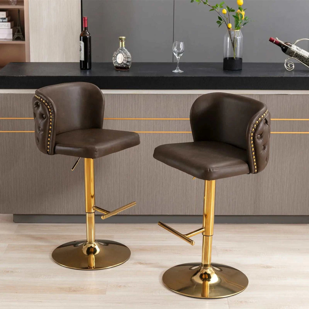 Two brown bar stools with gold bases in a kitchen setting.