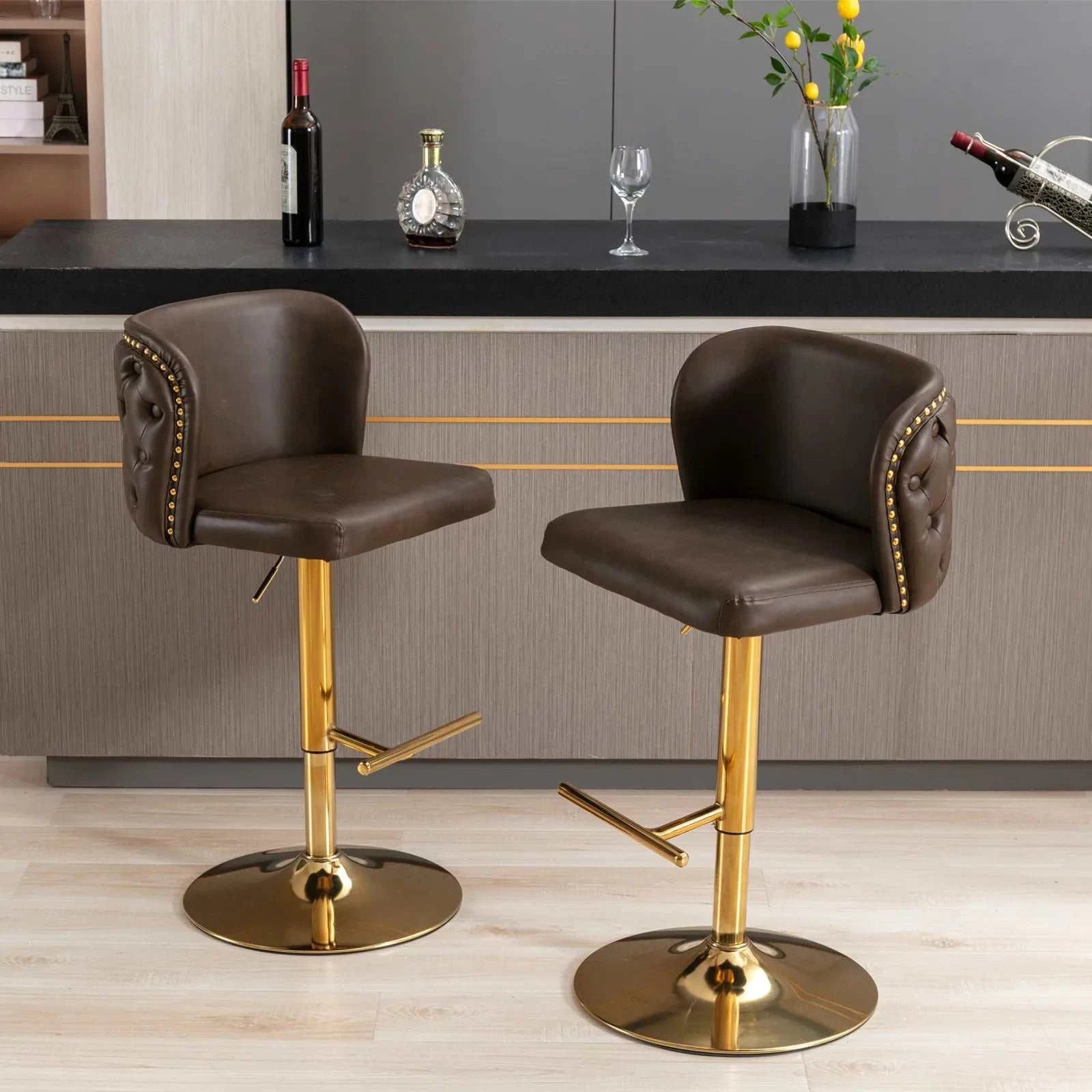 Two brown bar stools with gold bases in a kitchen setting.