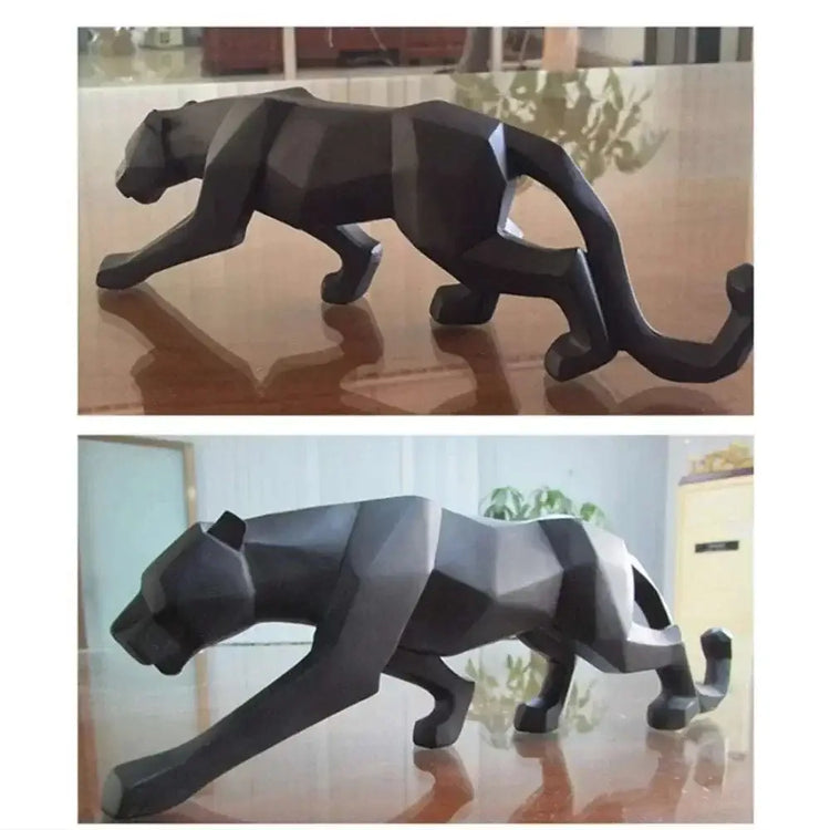 Black panther sculpture on a reflective surface with a blurred indoor background