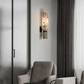Modern marble wall lamp illuminating a stylish interior space with elegant decor.