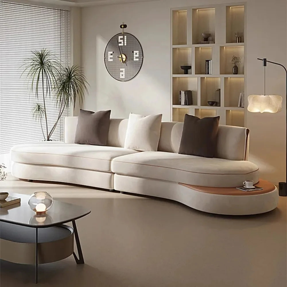 Modern living room with a white sofa, coffee table, and decorative items.
