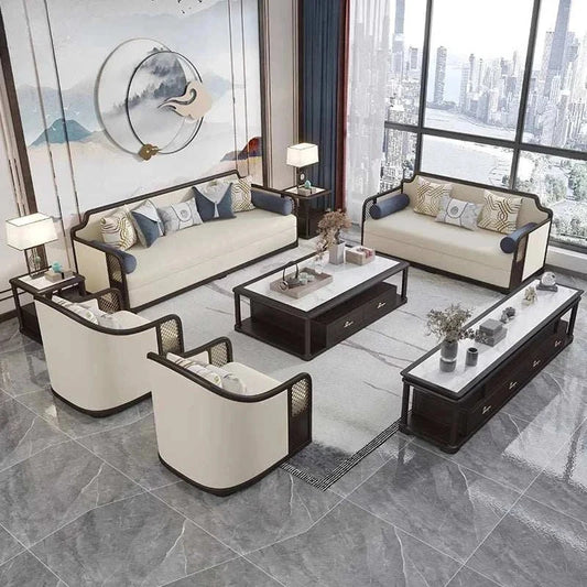 Modern designer living room set with modular cream sofas, armchairs, and dark wood tables in a spacious, light-filled apartment.
