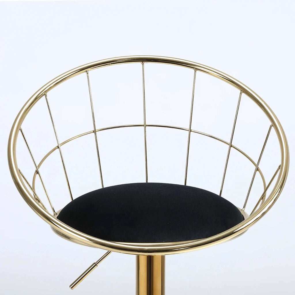Gold wireframe chair with a black cushion on a white background