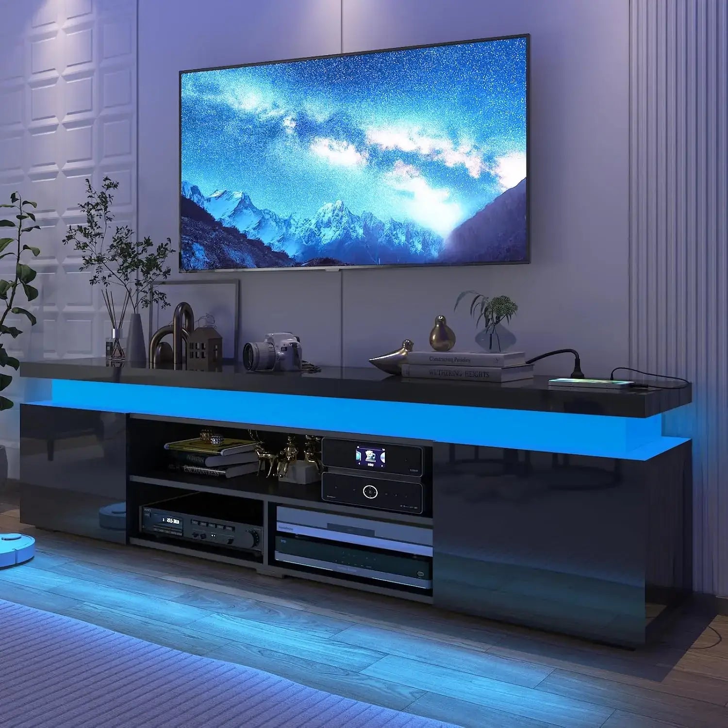 Modern LED TV stand for 85 inch TV with power outlet and high gloss finish showcasing the entertainment setup.