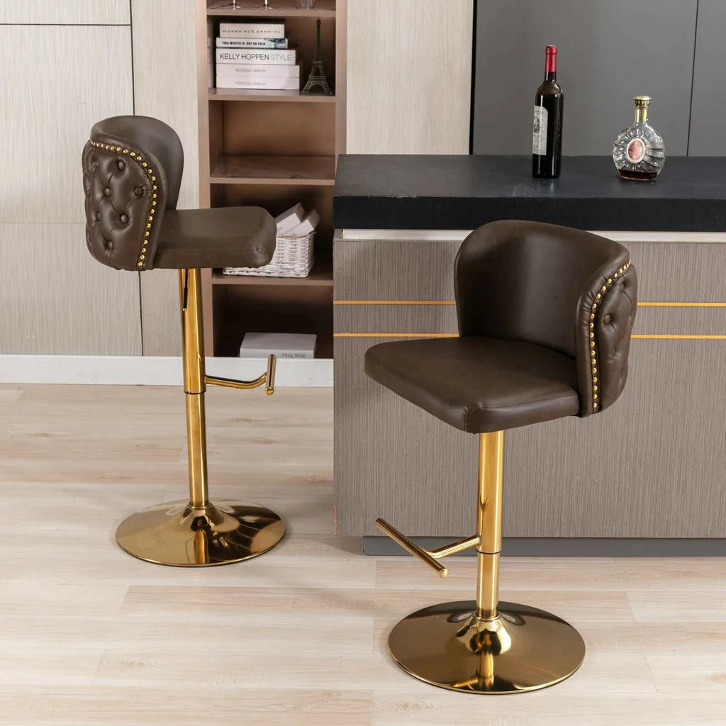 Two brown bar stools with gold legs in a modern kitchen setting.