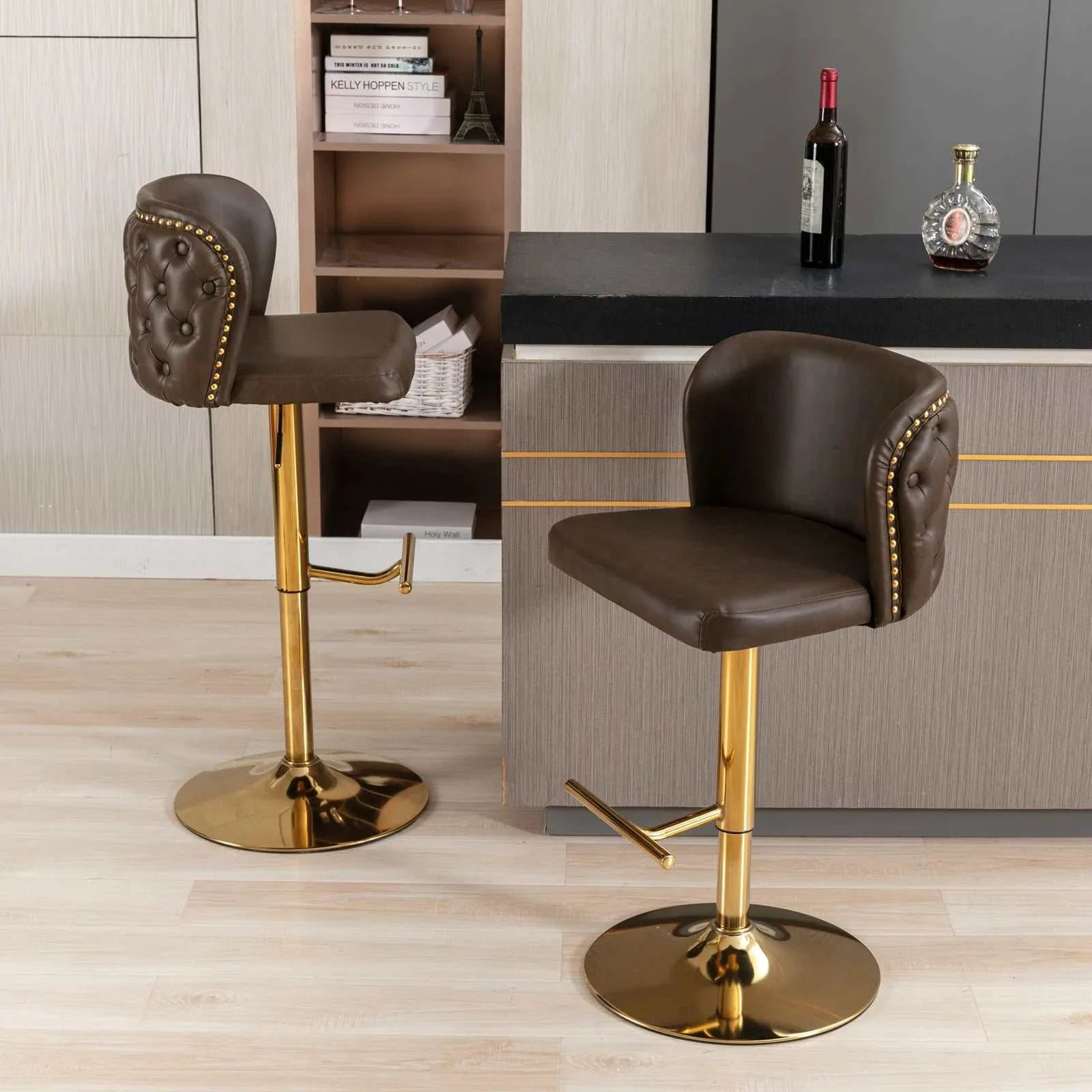 Two brown bar stools with gold legs in a modern kitchen setting.
