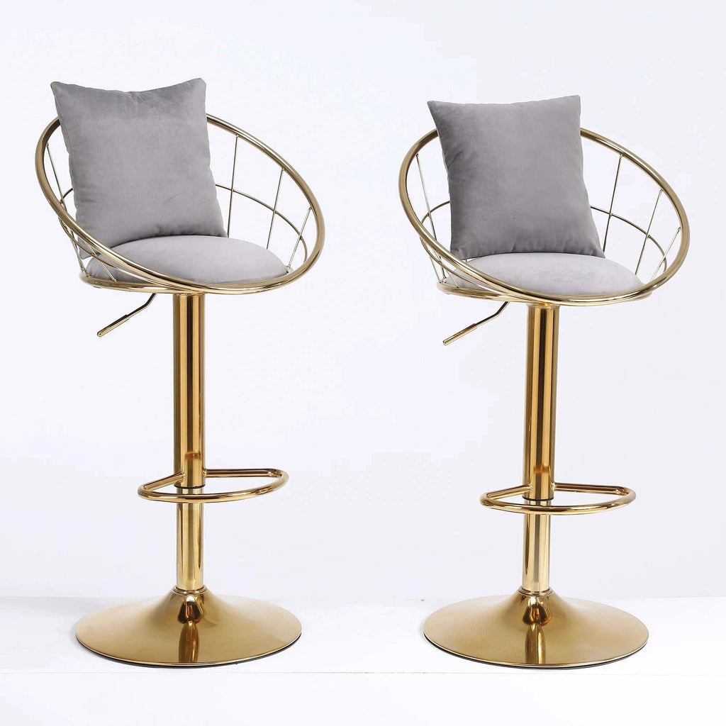 Two gold bar stools with gray cushions on a white background