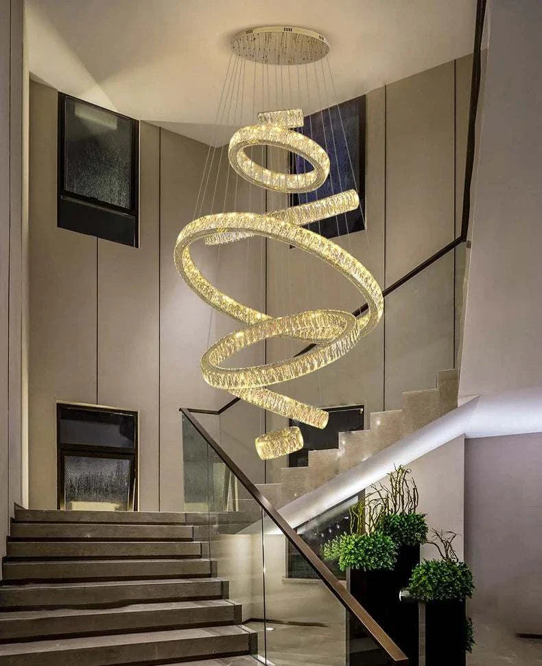 Elegant hall chandelier with modern spiral LED design above staircase in stylish interior