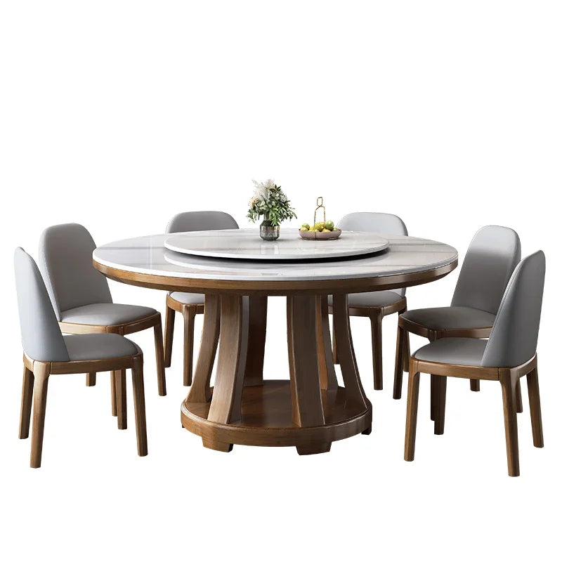 Round wooden dining table with marble top and six matching chairs on a white background